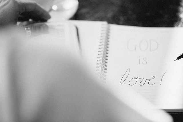 a notepad that says "God is love!"